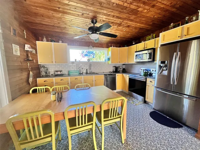 a kitchen with stainless steel appliances granite countertop a sink a stove and a refrigerator