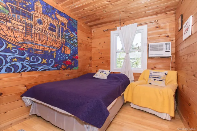 a bedroom with a bed and window