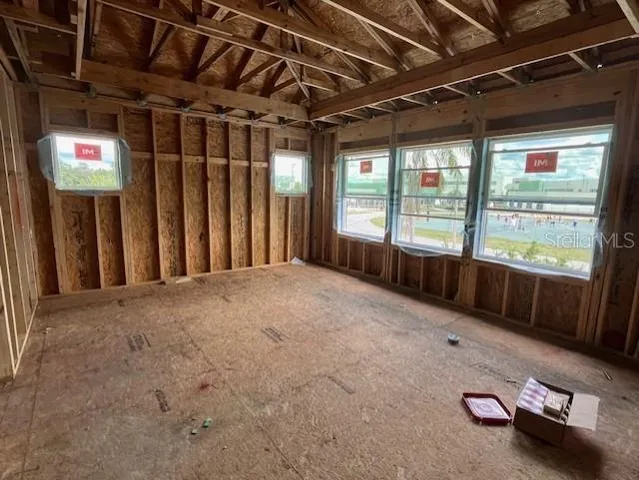 a view of an empty room and floor to ceiling window