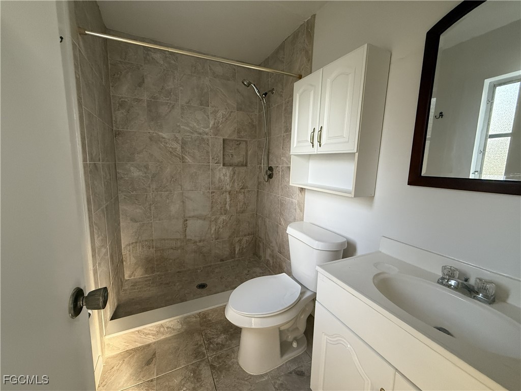 13013 2nd Street Fort Myers, FL 33905 - Photo 13 of 13 a bathroom with a sink toilet and shower
