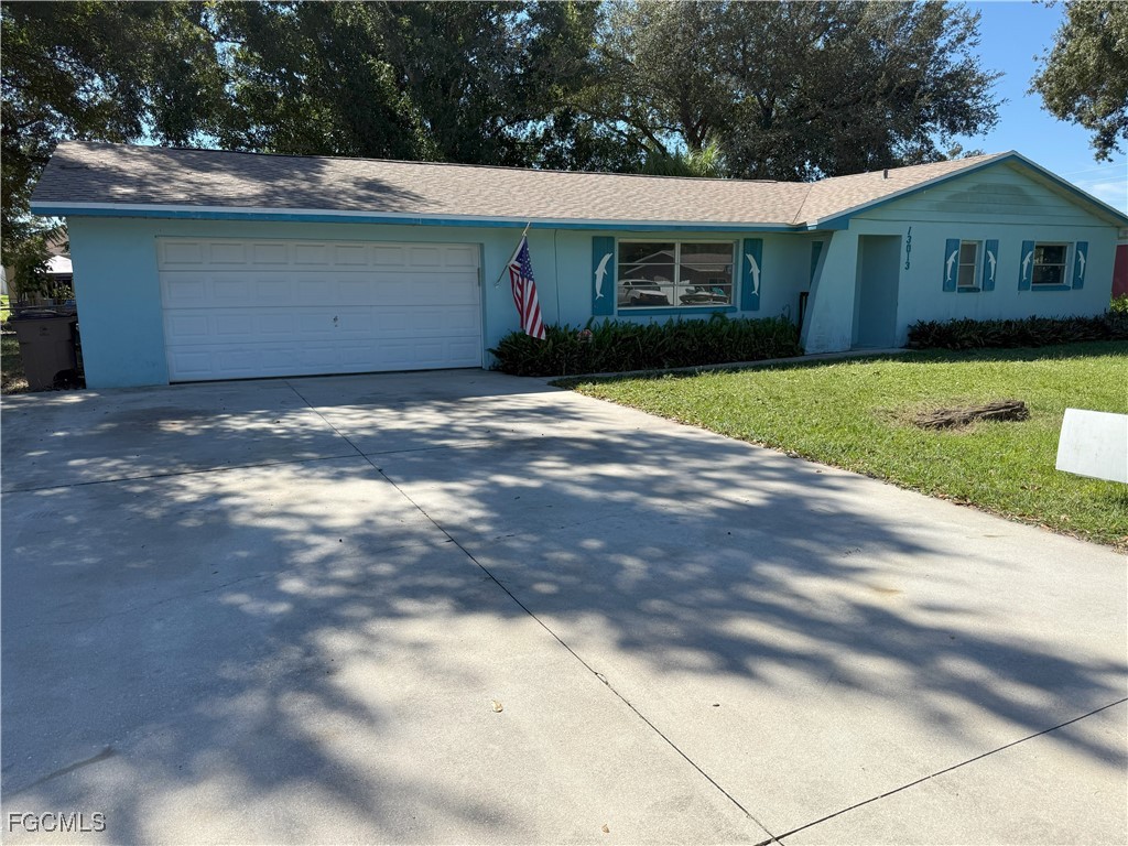 13013 2nd Street Fort Myers, FL 33905 - Photo 2 of 13 a front view of house with yard and green space