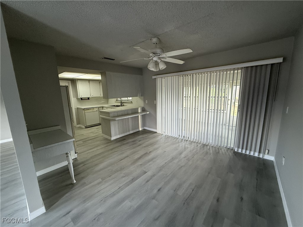 13013 2nd Street Fort Myers, FL 33905 - Photo 6 of 13 wooden floor in an empty room with a window