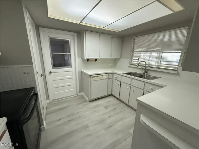 a kitchen with a sink stainless steel appliances and cabinets