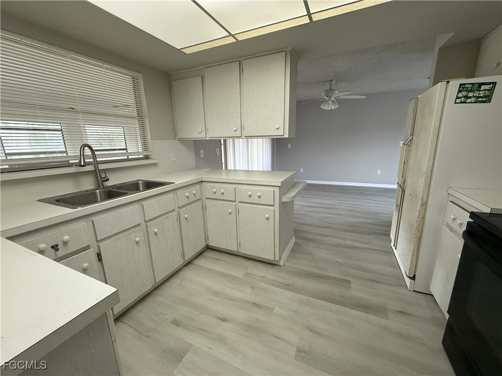 13013 2nd Street Fort Myers, FL 33905 - Photo 8 of 13 a kitchen with a sink cabinets stainless steel appliances and a window