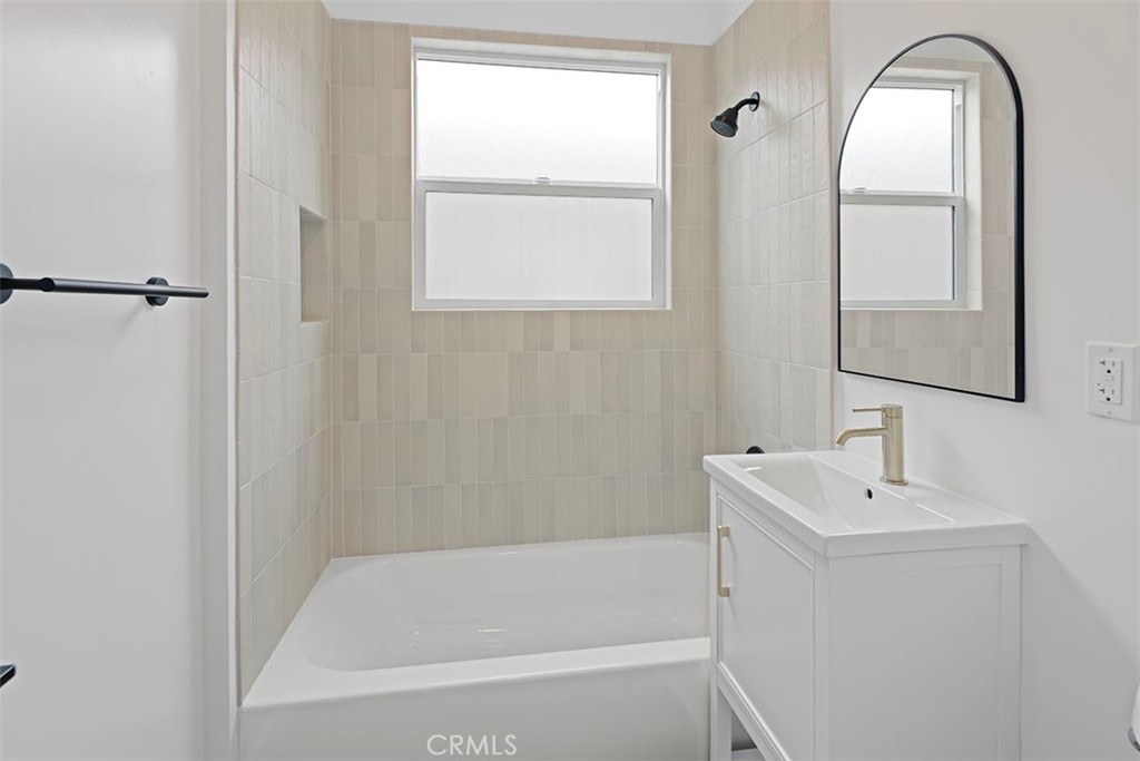 1827 East 4th Street, Unit 7 Long Beach, CA 90802 - Photo 12 of 37 a bathroom with a bathtub sink and mirror