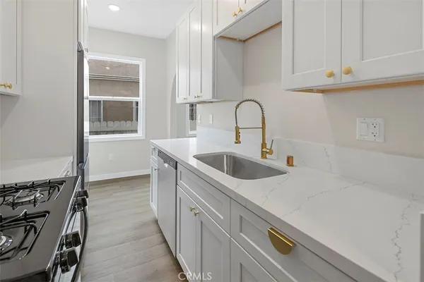 a kitchen with stainless steel appliances a sink and cabinets