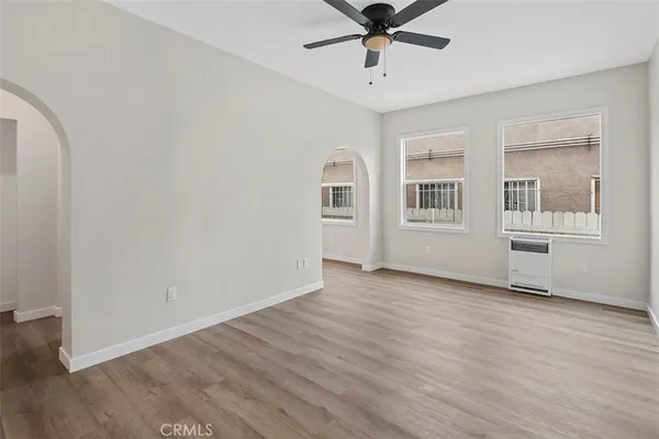 wooden floor in an empty room with a window
