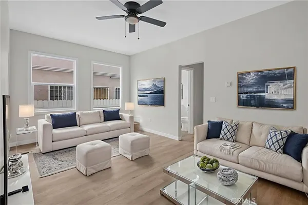 a living room with furniture and a wooden floor
