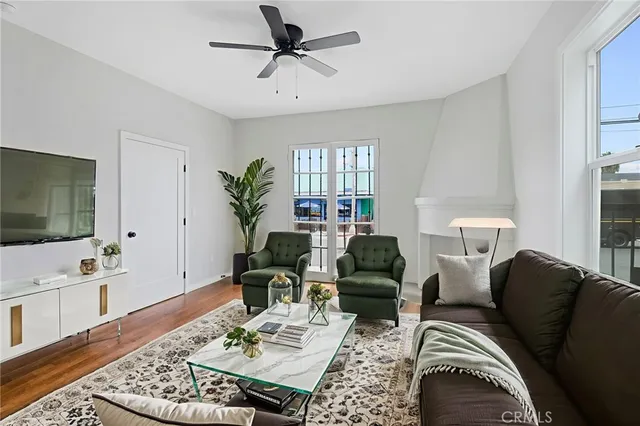 a living room with furniture a rug and a flat screen tv