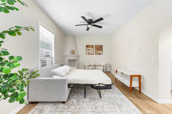 a bedroom with a bed and a potted plant