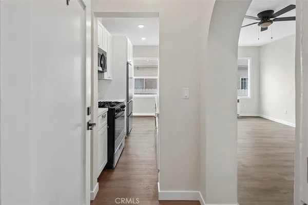 a view of a hallway with wooden floor