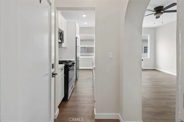 a view of a hallway with wooden floor