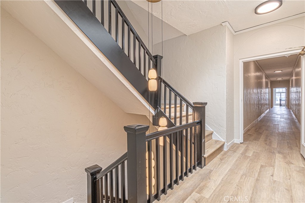 1827 East 4th Street, Unit 7 Long Beach, CA 90802 - Photo 5 of 37 a view of staircase with railing and a chandelier