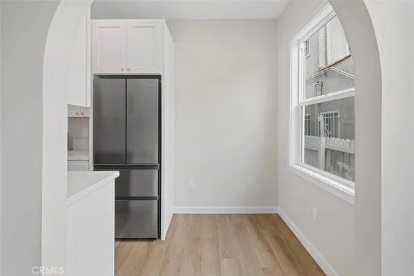 a view of a hallway with wooden floor and entryway