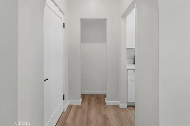 a view of a room with wooden floor and closet