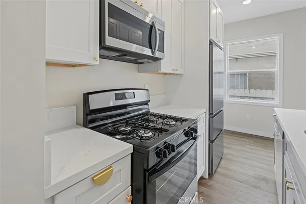 a kitchen with a stove and a microwave