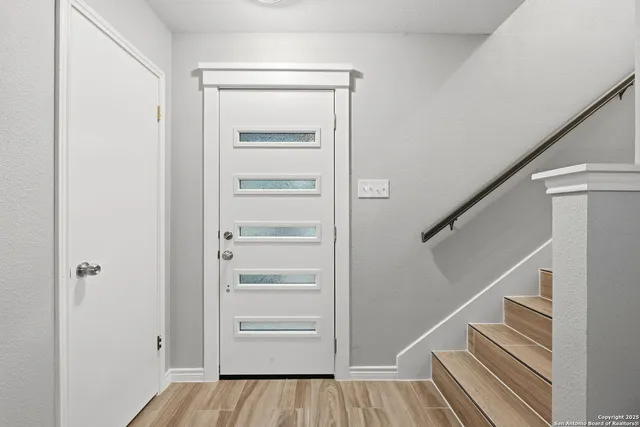 a view of walk in closet with wooden floor