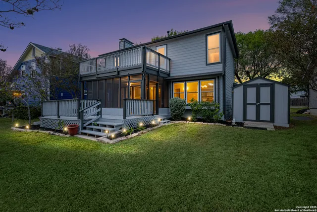 a view of a house with backyard and sitting area