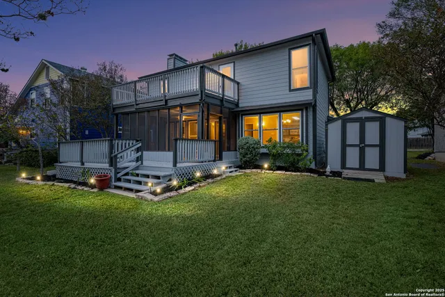 a view of a house with backyard and sitting area