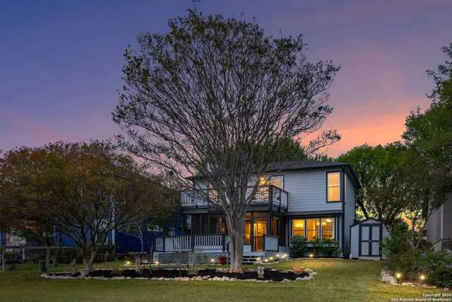 a front view of a building with trees