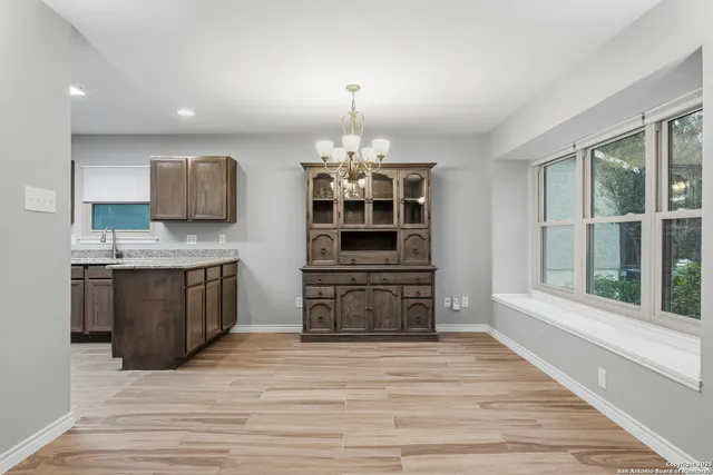 a kitchen with granite countertop a stove top oven and sink