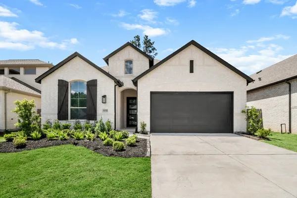 a front view of house with yard and garage
