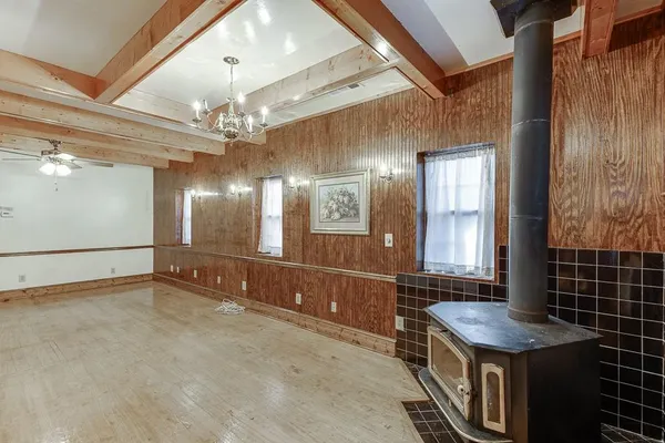 a kitchen with a dining table chairs and stove