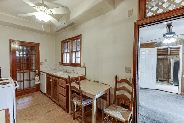 a kitchen with a stove a refrigerator and a table
