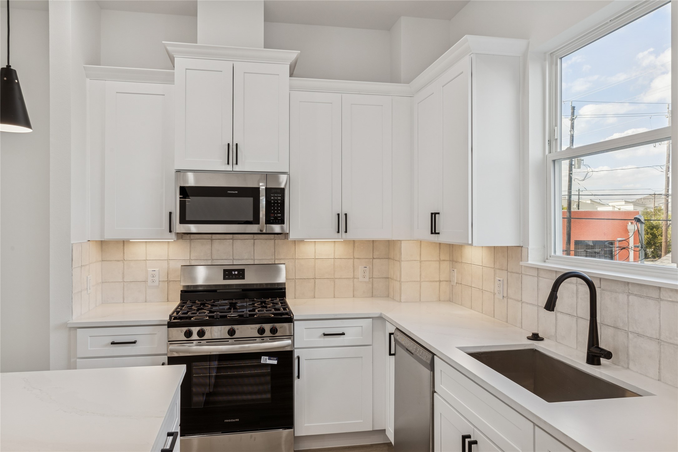 111 Milby Street Houston, TX 77003 - Photo 12 of 34 a kitchen with stainless steel appliances a sink a stove and microwave