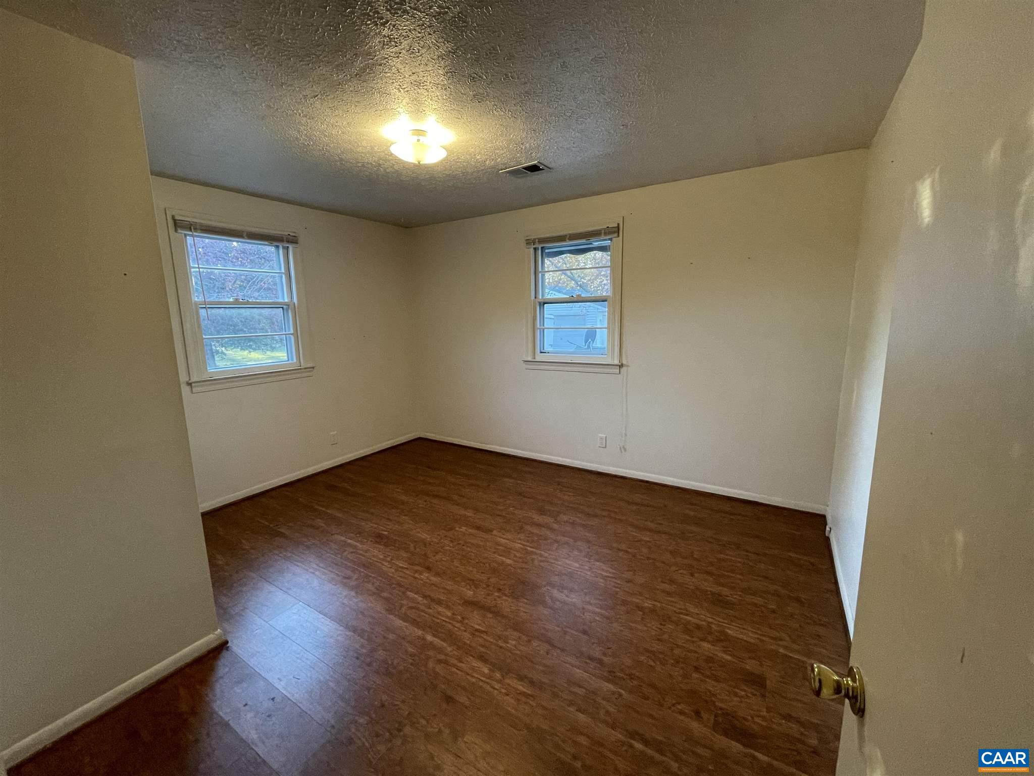 1997 Troy Road Troy, VA 22974 - Photo 8 of 19 an empty room with wooden floor and windows