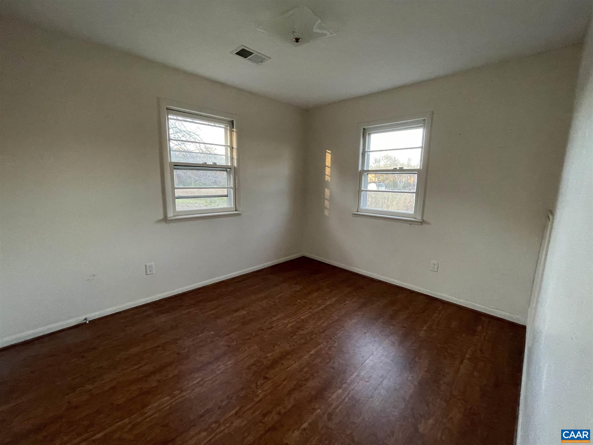 1997 Troy Road Troy, VA 22974 - Photo 9 of 19 a view of an empty room with wooden floor and a window