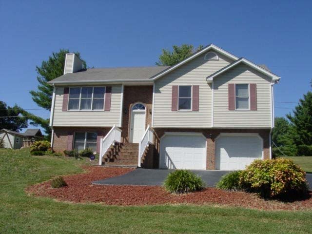 4661 Nemmo Road Vinton, VA 24179 - Photo 6 of 34 a front view of a house with a yard and garage