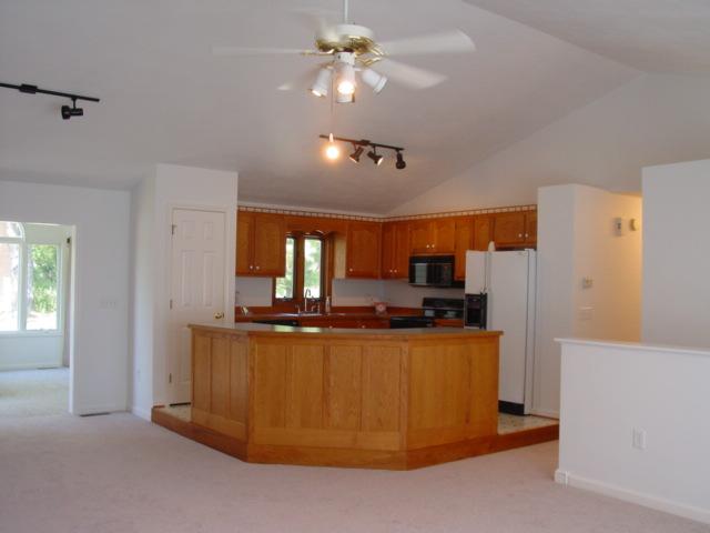 4661 Nemmo Road Vinton, VA 24179 - Photo 7 of 34 a kitchen with kitchen island a stove a refrigerator a sink dishwasher with a dining table and chairs