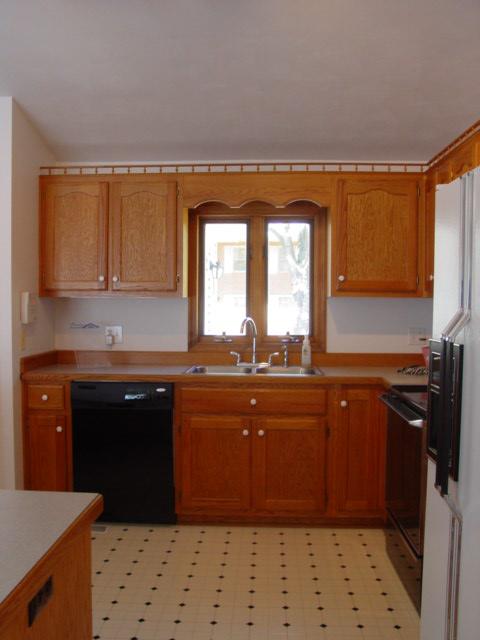 4661 Nemmo Road Vinton, VA 24179 - Photo 9 of 34 a kitchen with a sink a stove and wooden cabinets