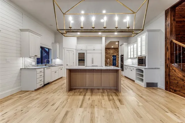 a kitchen with stainless steel appliances granite countertop a sink and cabinets