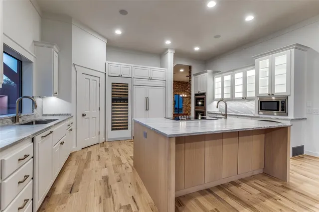 a kitchen with a sink window and cabinets