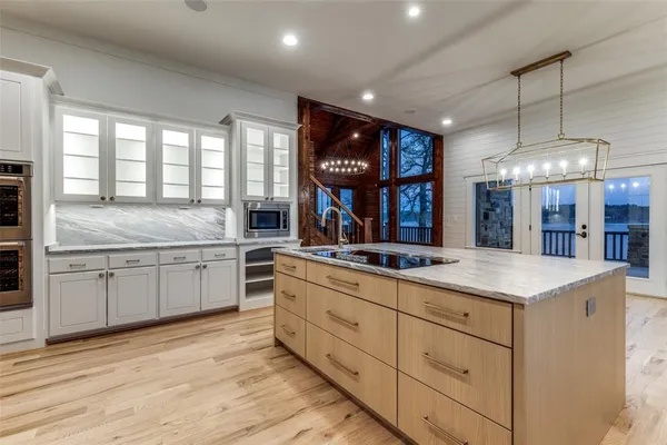 a kitchen with stainless steel appliances granite countertop a stove and a sink