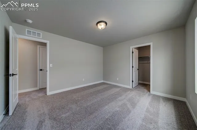 a view of an empty room with closet area