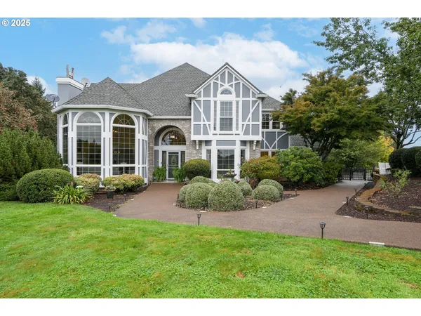 a front view of a house with a garden and plants