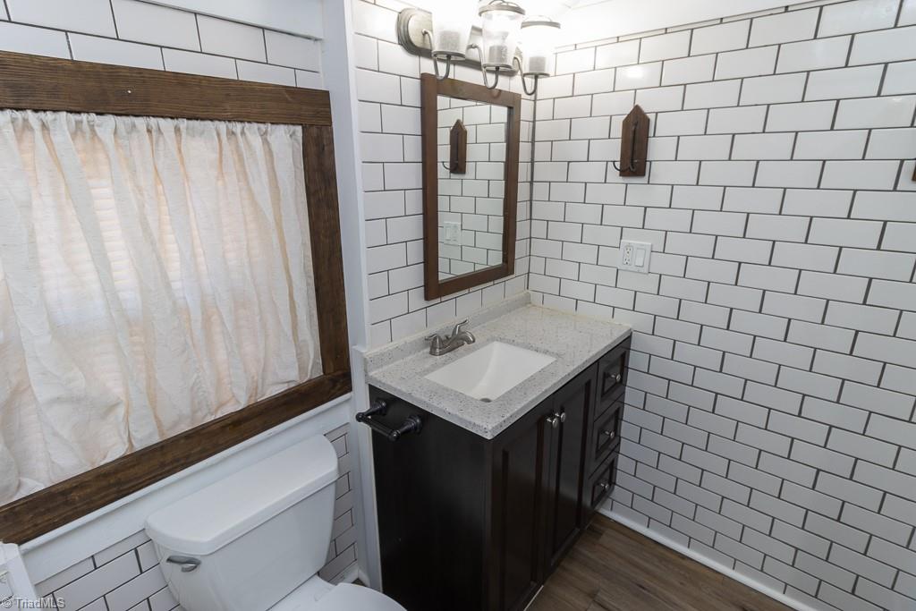 2327 Scalesville Road Summerfield, NC 27358 - Photo 11 of 22 SUBWAY TILE ALL OVER.. NEW VANITY AND SINK.