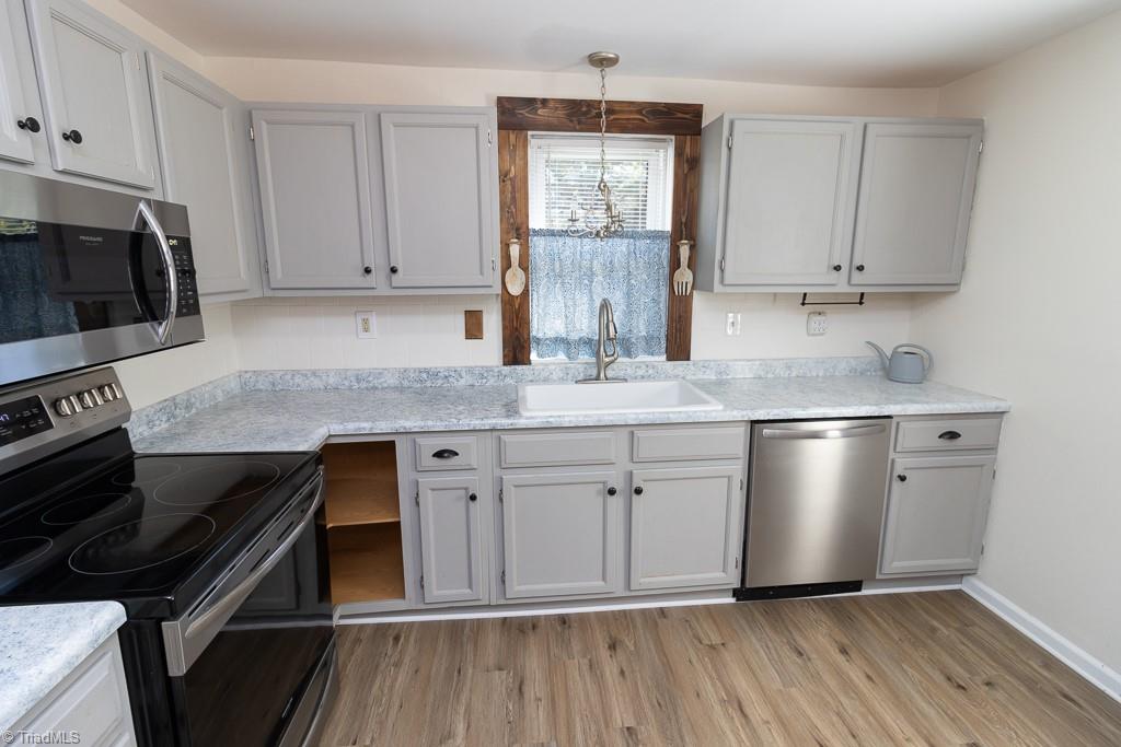 2327 Scalesville Road Summerfield, NC 27358 - Photo 16 of 22 ADORABLE KITCHEN.. NEW CABINETS, RANGE OVEN WITH GLASS TOP. MICROWAVE AND DISHWASHER