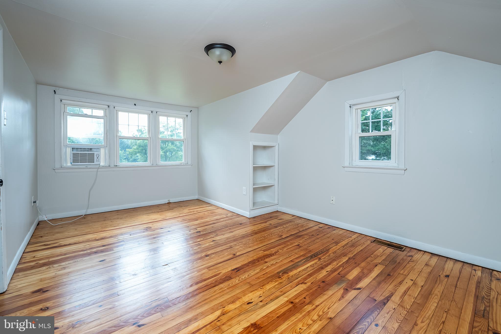 442 Saylors Mill Road Spring City, PA 19475 - Photo 11 of 26 an empty room with wooden floor and windows