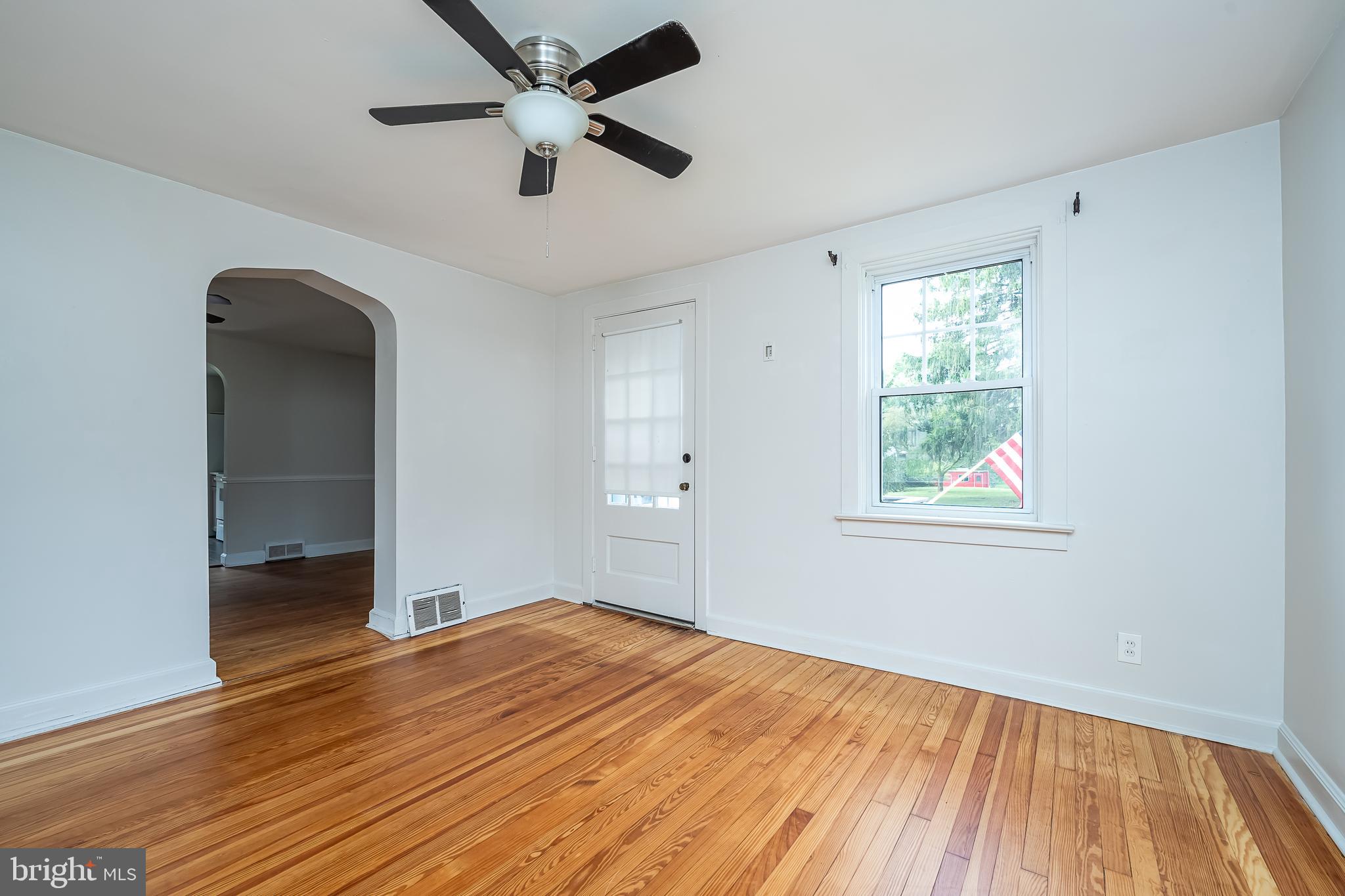 442 Saylors Mill Road Spring City, PA 19475 - Photo 13 of 26 an empty room with wooden floor and windows