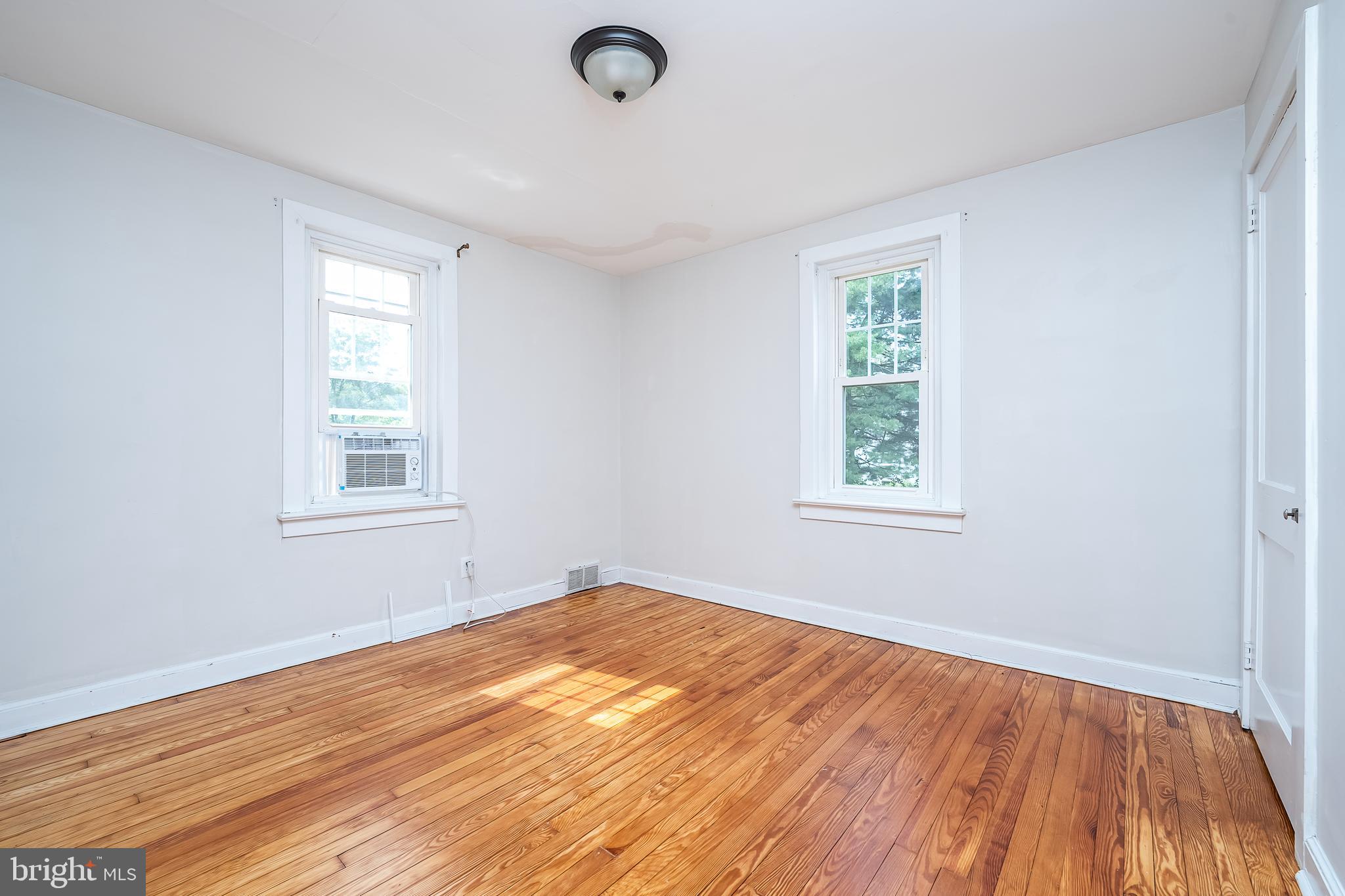 442 Saylors Mill Road Spring City, PA 19475 - Photo 14 of 26 a view of an empty room with wooden floor and a window
