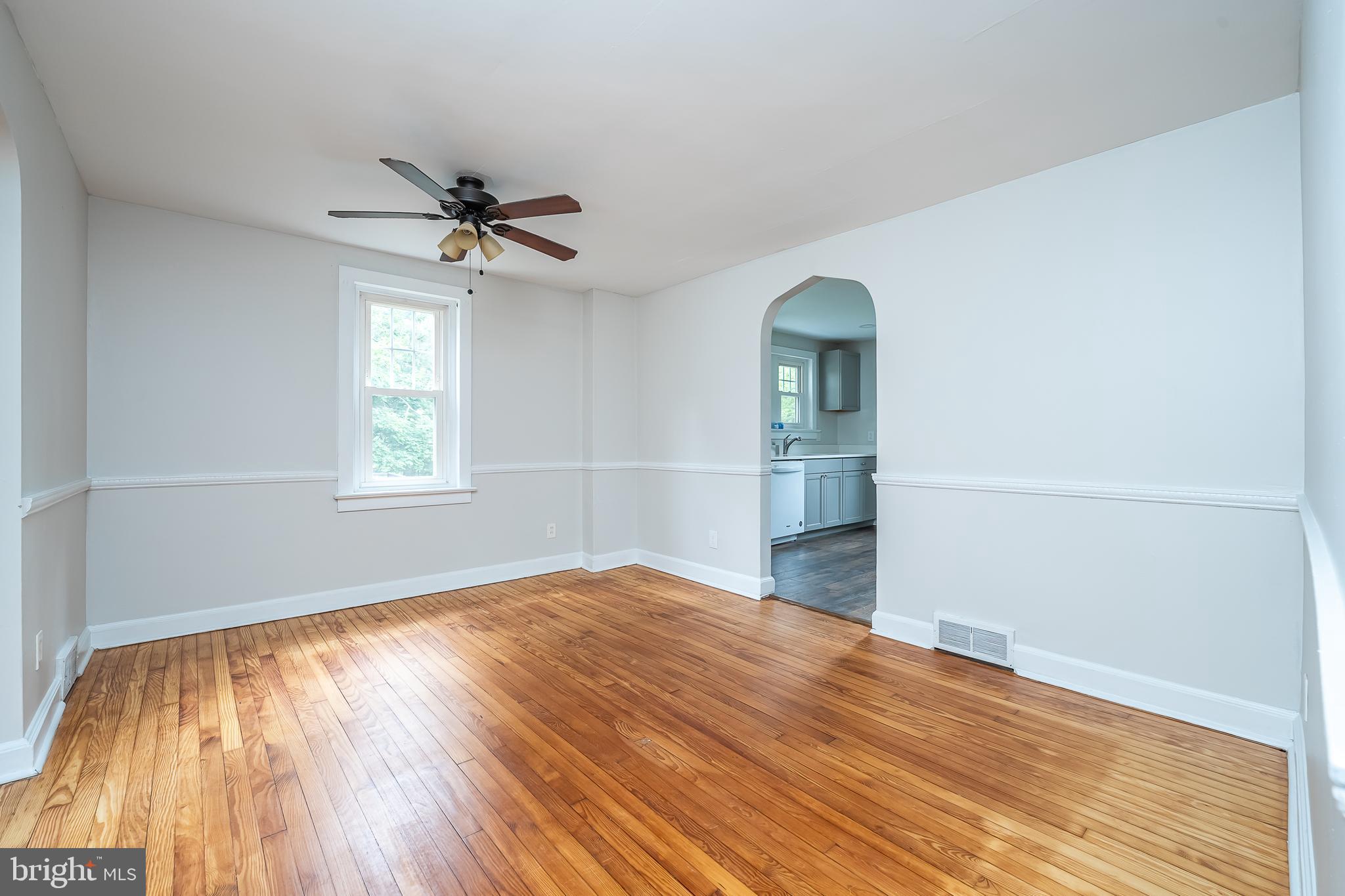 442 Saylors Mill Road Spring City, PA 19475 - Photo 4 of 26 an empty room with wooden floor chandelier and windows