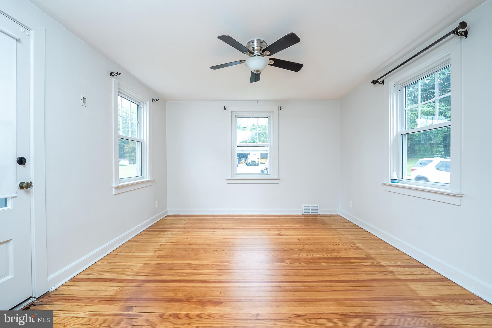 442 Saylors Mill Road Spring City, PA 19475 - Photo 6 of 26 a view of an empty room with wooden floor and a window
