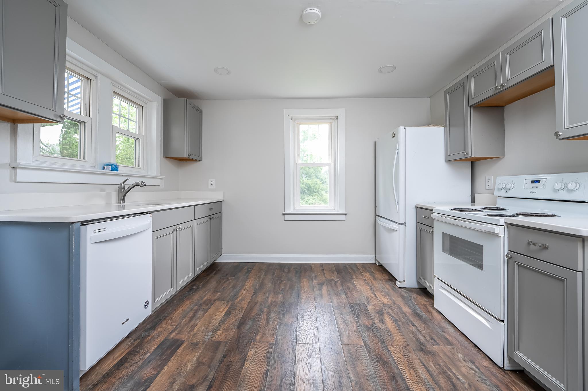 442 Saylors Mill Road Spring City, PA 19475 - Photo 7 of 26 a kitchen with a sink wooden floor and white appliances