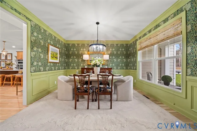 a dining room with furniture a chandelier and a rug