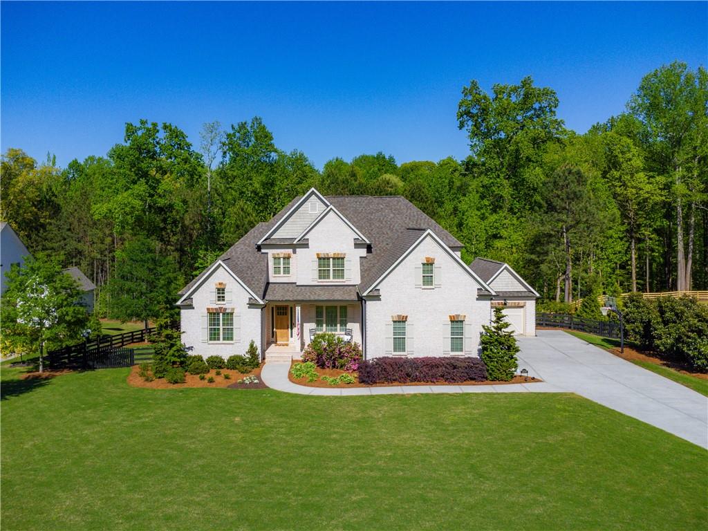 a view of house with garden and trees