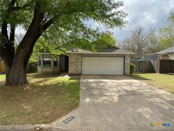 a view of a house with a yard and garage